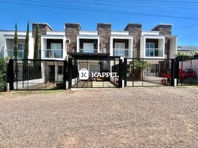 Fachada de um prédio residencial moderno com portão de segurança em Lajeado.