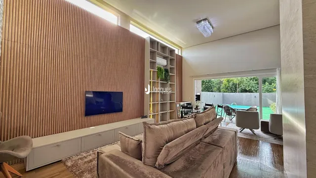 Sala de estar com sofá e televisão em um ambiente moderno.