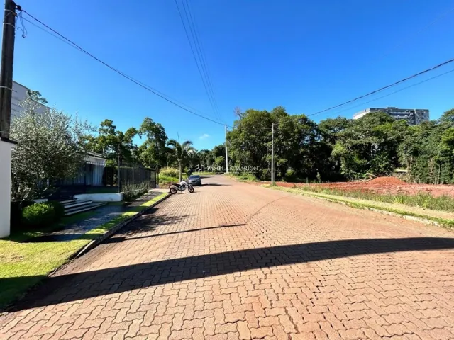 Vista externa de uma rua pavimentada em Lajeado, Brasil, com vegetação ao redor.