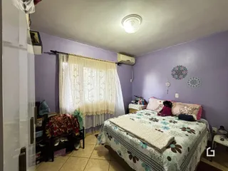 Quarto com cama e cortinas em uma sala de Lajeado, Brasil.