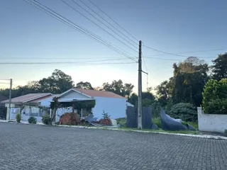 Fachada de uma residência em Lajeado, Brasil, com materiais de construção visíveis na frente.
