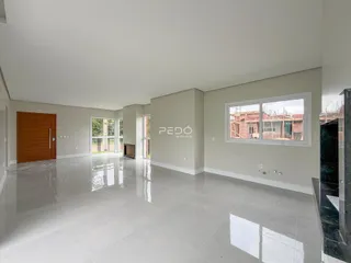 Espaço interno amplo com piso claro e janelas.