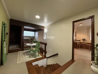 Uma sala de estar com acesso a outra área através de uma porta.