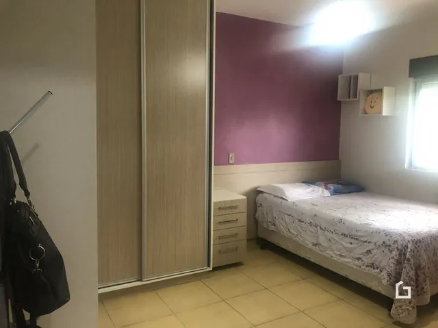 Quarto com cama e portas de correr em ambiente interno.