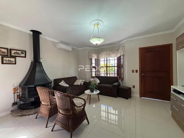 Sala de estar com lareira e móveis de madeira clara.