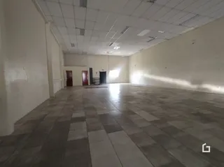 Foto do interior de um espaço amplo com piso de cerâmica.