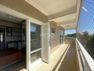 Vista de um quarto com acesso a uma varanda com piso de cerâmica.
