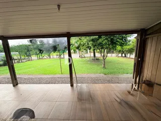 Um espaço interno se abre para um gramado verde.