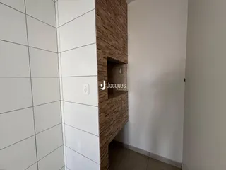 Parede com revestimento branco e painel de madeira na área interna da propriedade.