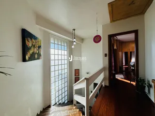 Interior de uma sala com escadaria e porta de vidro em Lajeado, Brasil.