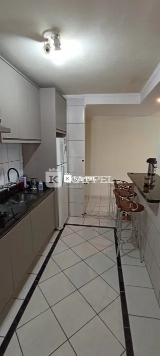 Foto de uma cozinha com armários brancos e piso de cerâmica.
