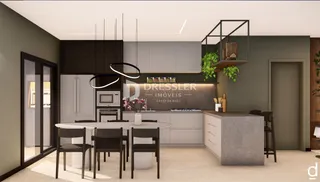 Vista de um ambiente moderno com cozinha e mesa de jantar em um imóvel.
