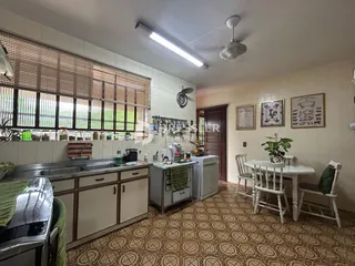 Foto de uma cozinha e sala de jantar em uma residência.