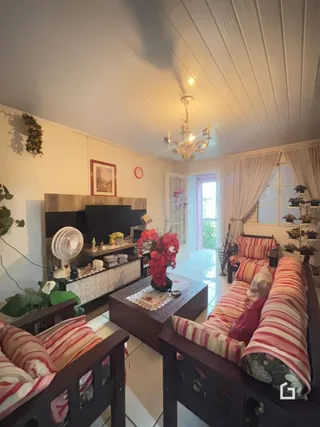 Sala de estar com decoração de madeira e paredes brancas.