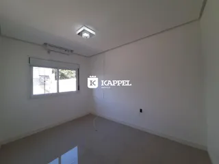 Foto de um ambiente interno com paredes brancas e piso claro.