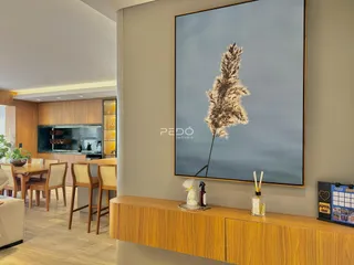 Interior de uma sala de estar com decoração moderna e piso de madeira.