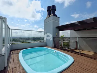 Uma piscina com deck de madeira em uma área externa.