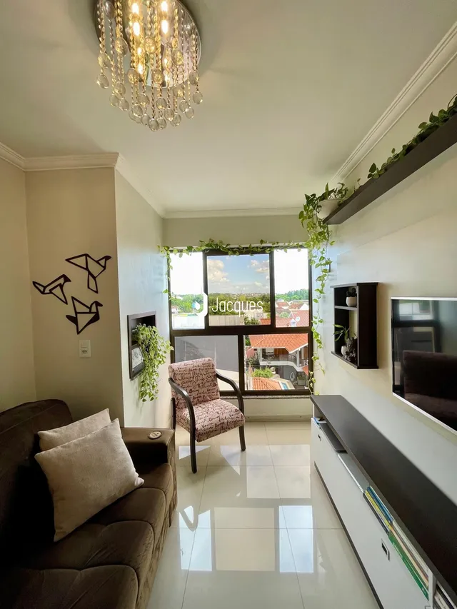Sala de estar com sofá e janela de grande porte em um imóvel no Brasil.