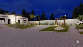 Fachada de uma residência em Lajeado, Brasil, com jardim e área externa pavimentada.