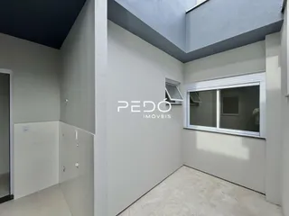Vista interna de um corredor com paredes brancas em um imóvel no Brasil.