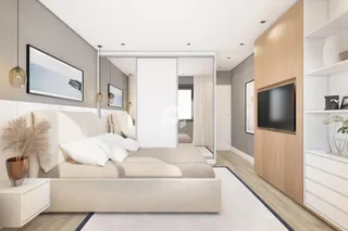 Quarto moderno com cama grande e decoração neutra.