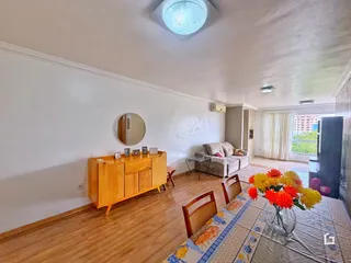 Foto de uma sala de estar com piso de madeira e móveis de madeira.