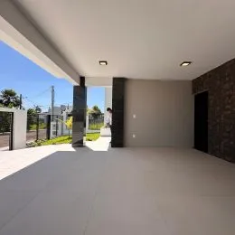 Foto de um espaço interno amplo com piso claro e teto branco.