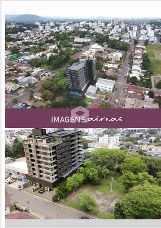 Vista aérea de um edifício residencial em Lajeado, Brasil, cercado por vegetação.