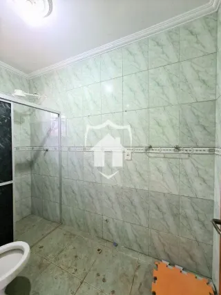 Parede revestida com azulejos claros em um ambiente interno.