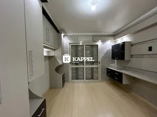 Ambiente interno com piso de madeira e armários modernos em um imóvel.