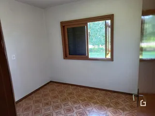 Interior de uma sala com piso de cerâmica e janela.