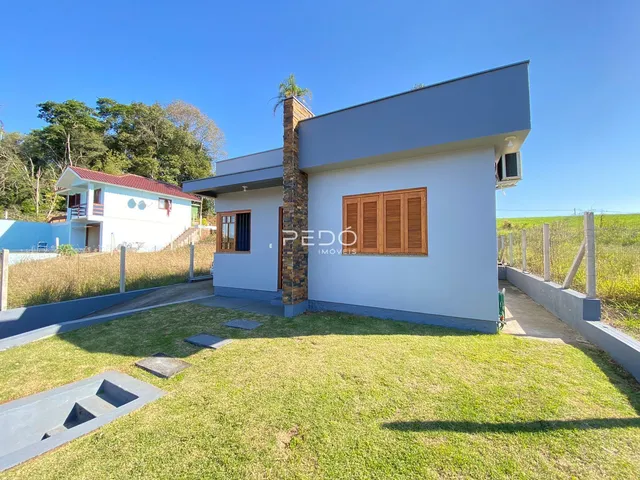 Fachada de uma casa moderna com jardim gramado em Lajeado, Brasil.