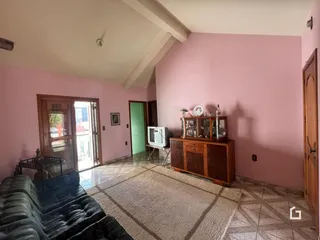 Sala de estar com paredes rosa e piso de cerâmica.