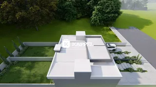 Vista aérea de uma residência com telhado e área gramada.