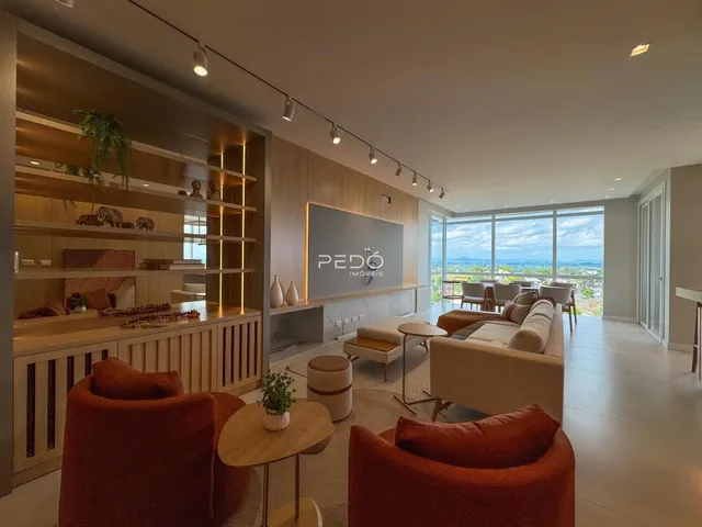 Sala de estar moderna com grandes janelas e vista panorâmica.