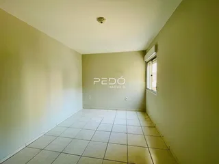 Hall de entrada com piso de cerâmica e paredes claras.