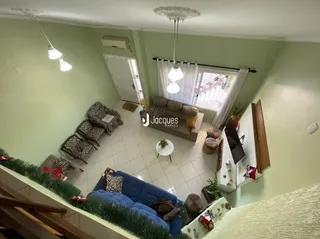 Vista interna de uma sala com paredes verde-claro e janela.