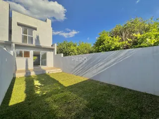 Fachada de uma casa moderna com jardim gramado.