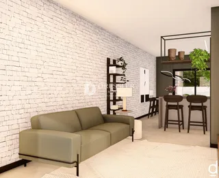 Uma sala de estar com parede de tijolos brancos e um sofá bege.