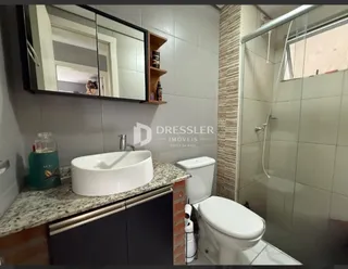 Foto de um banheiro interno com pia e vaso sanitário.