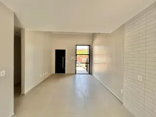 A foto mostra um corredor interno com paredes brancas e piso claro.