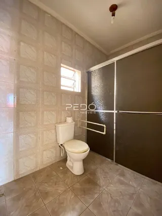 Foto de um banheiro com paredes de azulejo claro.
