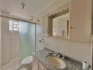 Banheiro com bancada e box de vidro em imóvel no Brasil.