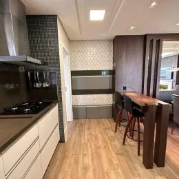 Foto de uma cozinha com armários e bancadas em um imóvel.