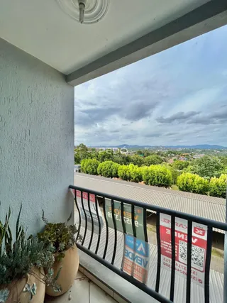 Vista da propriedade com paisagem verde ao fundo.