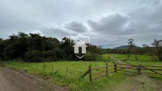 Paisagem rural com campo gramado e cerca de madeira em Lajeado.