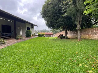 Vista da fachada de uma residência com jardim gramado.