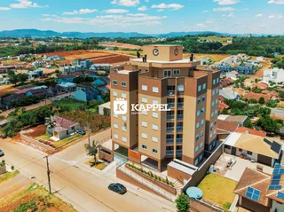 Vista aérea de um prédio de apartamentos em Lajeado, Brasil, mostrando sua fachada e entorno.
