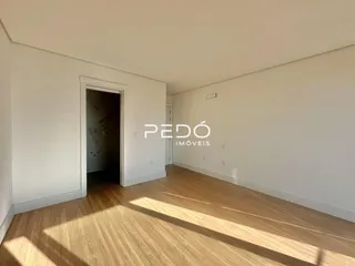 Ambiente interno com piso de madeira e porta de acesso.