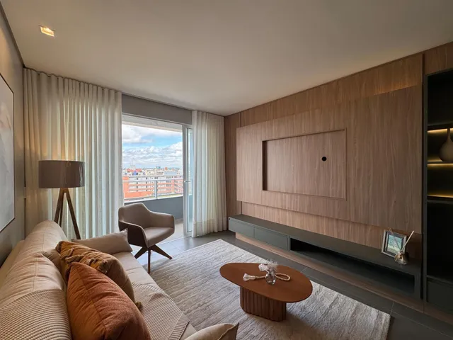 Sala de estar com sofá e vista panorâmica da cidade.